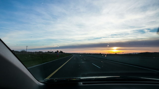 Driving on motorway during sunset, time laps