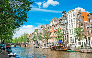 Amsterdam canals and typical houses with summer sky - obrazy, fototapety, plakaty