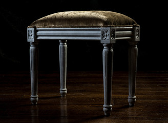 Vintage hassock with velvet upholstery and carved legs
