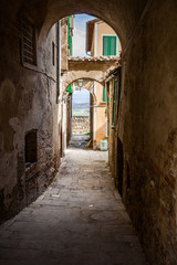 Fototapeta na wymiar Narrow Street in an Old Italian Town. Tuscany, Italy
