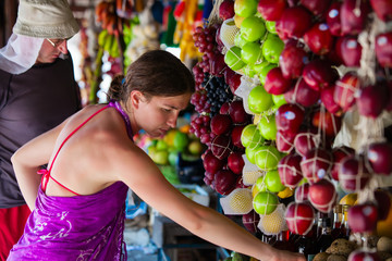 Woman chooses fruits at local market in Sri Lanka