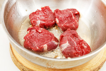 beef steak in a frying pan