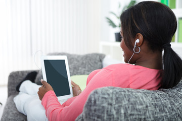 Woman relaxing with tablet