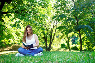 Young woman reading in park