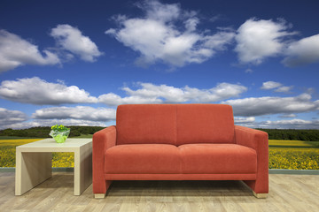 Fototapeta na wymiar Auszeit rotes Sofa mit Landschaft im HIntergrund