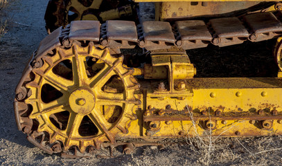 Fototapeta na wymiar Yellow Tractor track on dirt