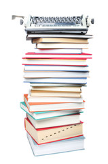 Stack of books and typewriter on white background