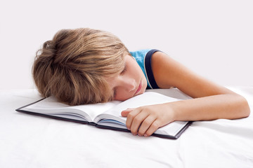 child sleeping with book