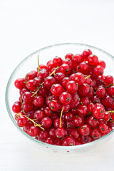Bowl of red currant on light background