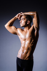 Muscular man in dark studio