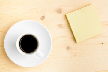 yellow sticker note and a cup of coffee