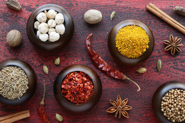 Set of various Indian spices on rusted wooden background