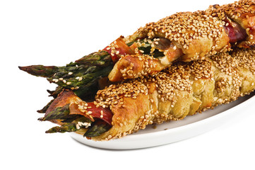 bunch of asparagus rolled with  puff pastry and speck