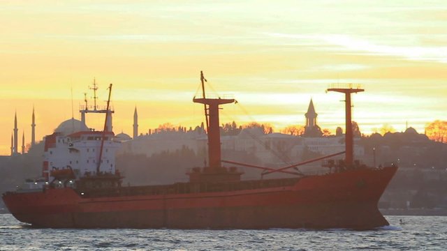 Cargo ship sails on sunset in Istanbul