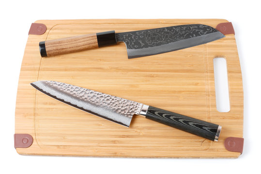 Two top grade japanese knives on cutting board