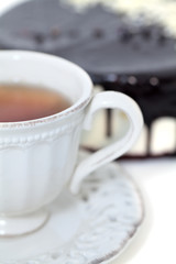 cup of tea and cake with chocolate icing