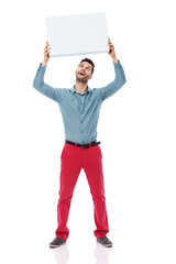 Happy man holding a blank sign overhead
