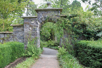 Splendid stone archway in English country garden