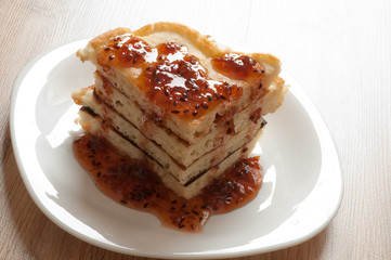 A stack of pancakes with jam gooseberry