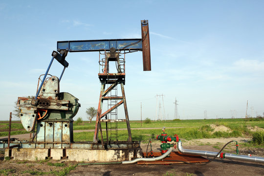 oilfield with pump jack and pipeline