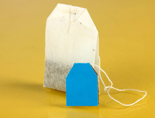 Tea bag on yellow background