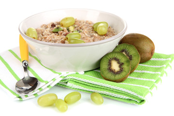 Useful oatmeal in bowl with fruit isolated on white