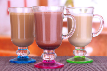 Layered coffee in glass on table on bright background