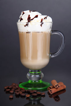 Layered coffee in glass on table on grey background