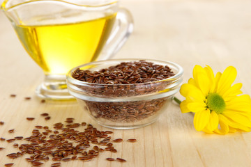 Useful linseed oil on wooden table close-up