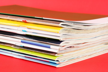 Many magazines on red background