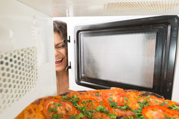 Girl open a microwave