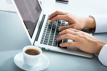 Businessman typing on laptop