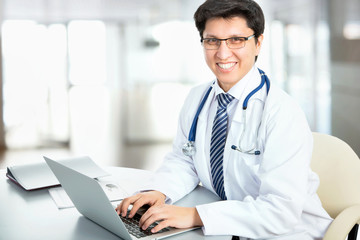 Medical doctor working with laptop