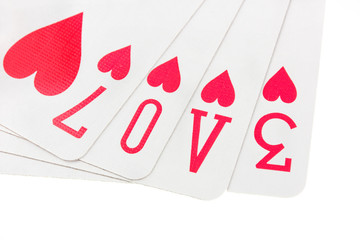Playing cards spelling the word love on white