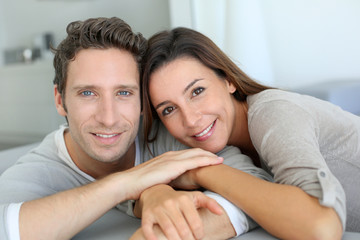 Portrait of sweet couple sitting in sofa