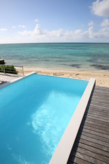 Fototapeta na wymiar Beautiful view of infinity pool with wooden deck