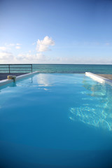 Fototapeta premium Closeup of infinity pool getting to the sea