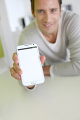 Closeup on smartphone screen held by man's hand