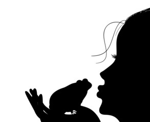 Silhouette of a young girl kisses a frog