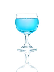 Wineglass with blue liquid, isolated on white background