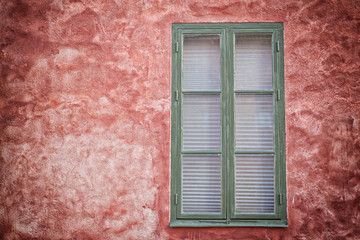 Green window on red wall.