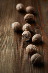 Nutmeg on rustic wooden background