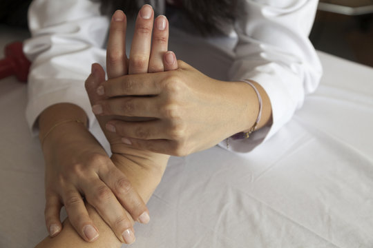 Physical therapist giving a hand massage