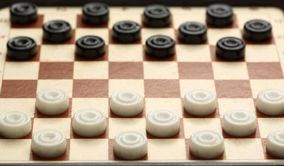 Travelling draughts on playing field