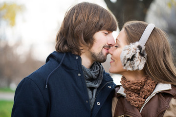 Happy young couple kissing outdoor