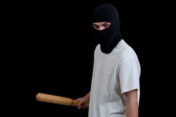 Masked man preparing to attack with bat