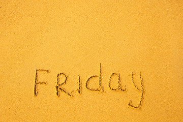 Friday - written in sand on beach texture.