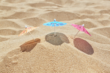 Fototapeta na wymiar Small beach umbrellas on the beach near the sea.