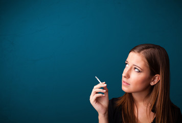 Beautiful woman smoking cigarette vith copy space