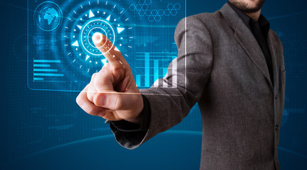 Businessman pressing high tech type of modern buttons